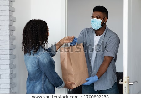 Stockfoto: Young Woman Shopping Groceries For People In Covid 19 Quarantine