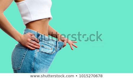 Stock foto: Woman With Large Jeans In Dieting Concept