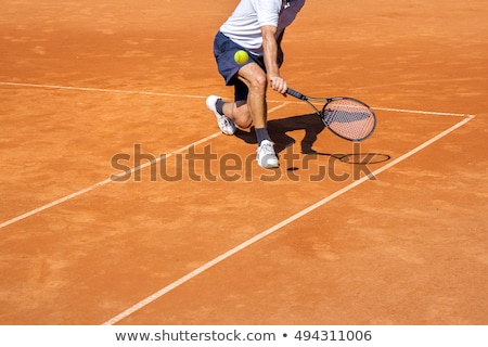Stock fotó: Male Tennis Player In Action On The Clay Court On A Sunny Day