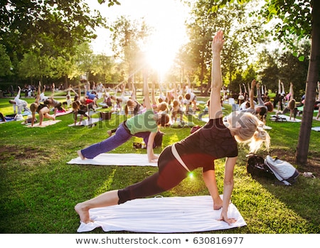 Stock photo: Big Group Of Adults Attending A Yoga Class Outside In Park