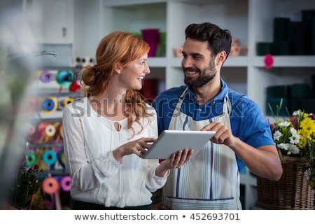[[stock_photo]]: Seller With Tablet Computer At Flower Shop