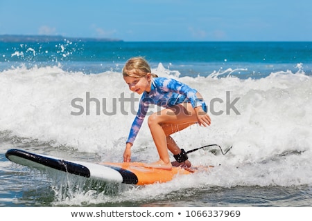 Stock fotó: Happy Young Girl With Surfboard At Beach