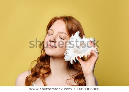 Stock fotó: Woman Holding Shell In Her Hands