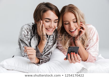 Stockfoto: Two Women In Grey Pajamas Sleeping On Bed