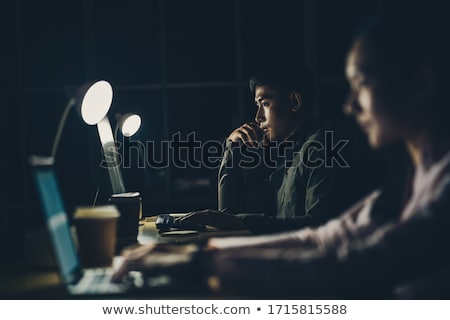 Foto stock: Business Team With Computer Working Late At Office