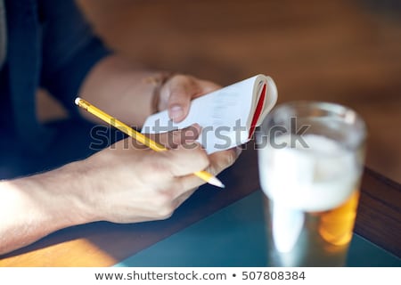 Zdjęcia stock: Man With Beer Writing To Notebook At Bar Or Pub