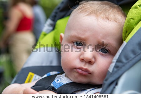 Stockfoto: Portrait Of A Cute Little Boy Sitting On A Carriage