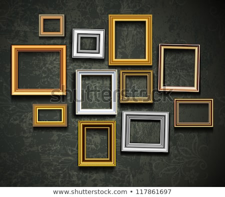 Foto stock: Golden Empty Picture Frame At The Wall