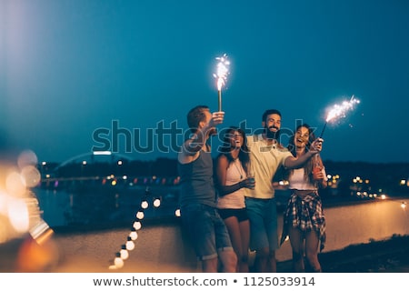 Zdjęcia stock: Happy Friends With Sparklers At Rooftop Party