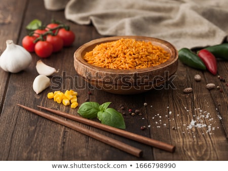 Stok fotoğraf: Wooden Bowl With Boiled Red Long Grain Basmati Rice With Vegetables On Wooden Table Background With