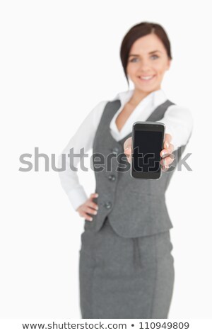 Stock photo: Smiling Businesswoman Showing A Cellphone Against A White Background