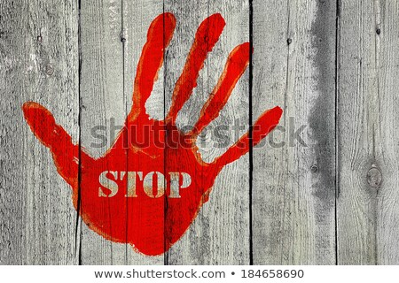 Stock photo: Handprint With The Word Stop On Old Wooden Fence Background