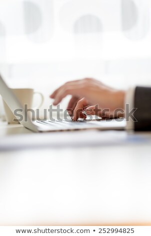 Stock foto: Focused Technician Typing On His Notebook