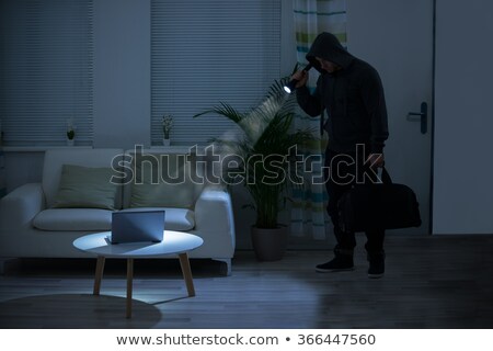 Stockfoto: Robber Holding Flashlight Over Laptop At Home