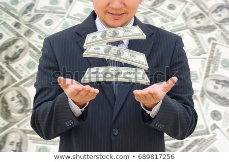 Foto stock: Man Catching Money Falling From The Sky