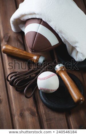 Stockfoto: Football And Baseball Equipment On Rustic Wooden Boards