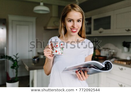 [[stock_photo]]: Woman With Long Hair And Red Lipstick Holding Tea Cup