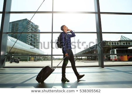 Stok fotoğraf: African Man With Suitcase Talking On Phone