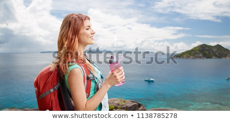 Foto d'archivio: Happy Woman With Backpack Over Seychelles Island