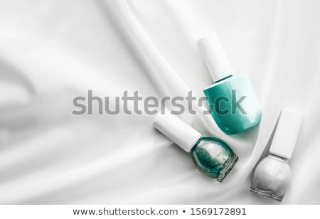 Foto d'archivio: Nail Polish Bottles On Silk Background French Manicure Products