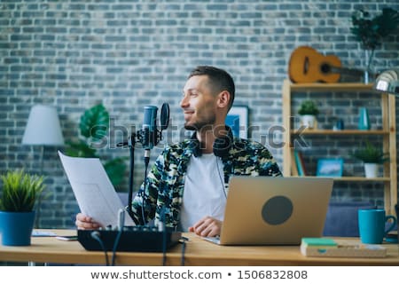 Stock foto: Blogger With Laptop And Microphone Audio Blogging
