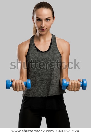 Stockfoto: Young Woman Making Exercise In Gym With Dumbbell