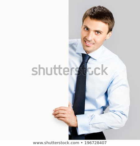 Stock foto: Business Man Handing A Blank Business Card Over Grey Background