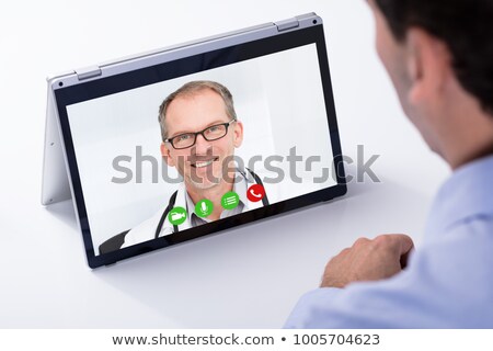 [[stock_photo]]: Man Looking At Blank Hybrid Laptop