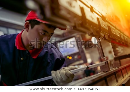 Foto stock: Engineer Operating Manufacturing Line In Electronics Factory