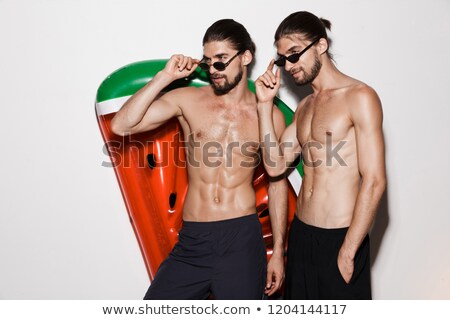 Stock fotó: Portrait Of A Smiling Shirtless Twin Brothers Standing