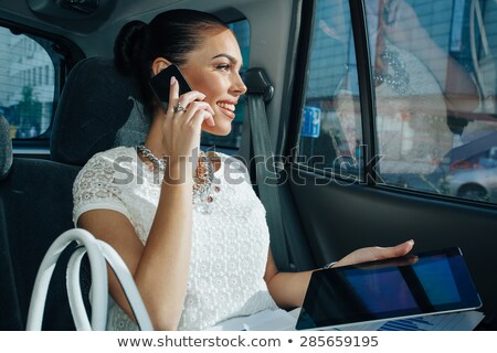 Сток-фото: Businesswoman Sitting In Car Holding Digital Tablet
