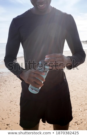 Stock fotó: Happy Young African Sportsman At The Beach