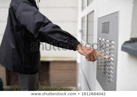 Stockfoto: Male Bailiff Standing At House Entrance