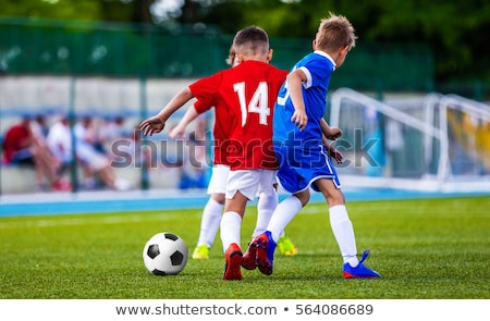 Back Of Junior Football Player Playing Game On The Field Stockfoto © matimix