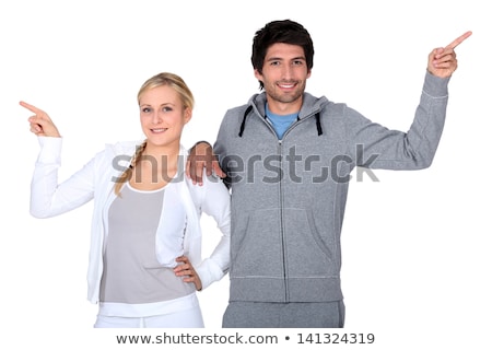 Stock photo: Happy Couple Training Together Pointing At Different Directions