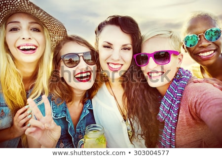 Foto stock: Group Of Smiling Young Women Drinking On Beach