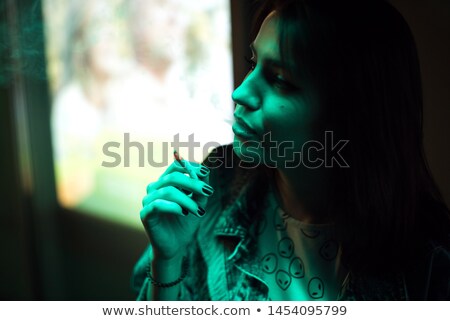 Foto d'archivio: Young Woman Lighting Cigarette