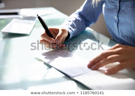 Stok fotoğraf: Businesswoman Signing Cheque