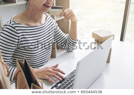 Stockfoto: Happy Woman Using Smart Phone And Credit Card Register Payments