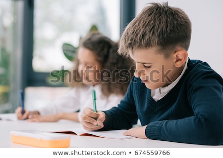 Stock foto: Schoolboy And Schoolgirl Sitting By Desk At Lesson