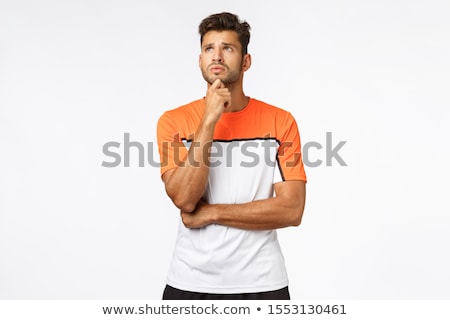 Stock photo: Concerned Worried Young Handsome Male Athlete In Activewear Rub Chin And Look Up Anxious Thinking