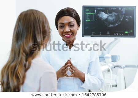 Stock foto: Gynecologist Showing Woman Early Ultrasounds Of Her Pregnancy