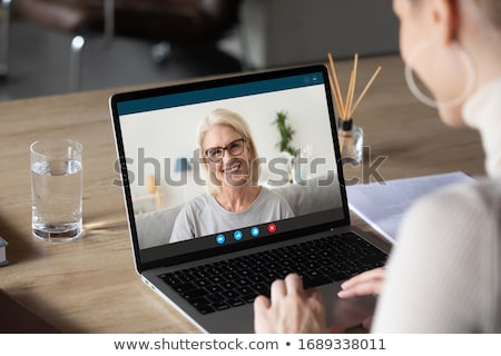 Foto stock: Optimistic Young Woman Using Laptop Computer