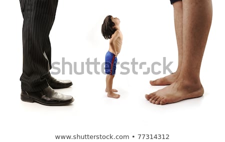 Little Small Child Is Looking At The Giant Legs Of Two Men Businessman And Barefoot One Foto stock © Zurijeta