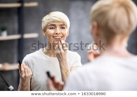 Stock fotó: Woman Applying Lipstick On Lips Natural Beauty