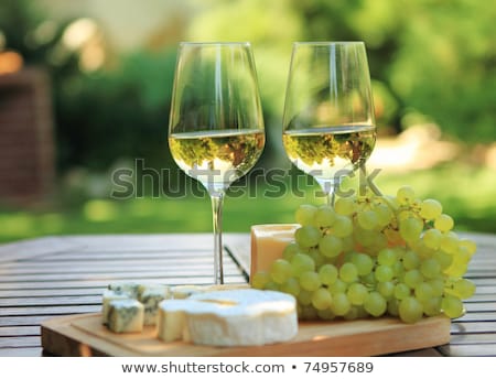 [[stock_photo]]: Two Glasses Of White Wine Blue Cheese And A Grapes