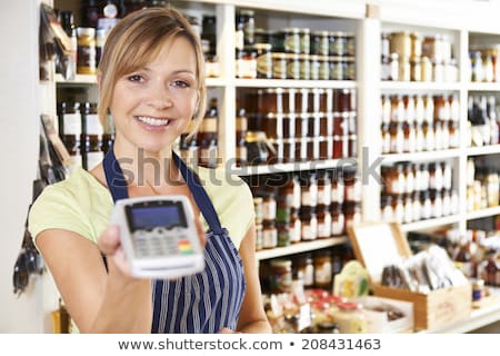 Zdjęcia stock: Sales Assistant In Food Store With Credit Card Machine