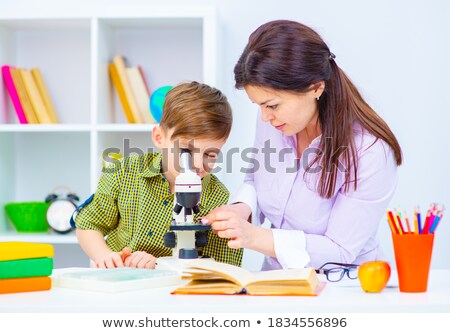 Foto stock: Child Showing A Pen To His Home Teacher