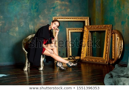 Foto stock: Beauty Rich Brunette Woman In Luxury Interior Near Empty Frames Vintage Elegance