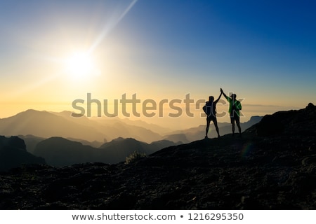 Foto stock: Teamwork Couple Climbing And Reaching Mountain Peak